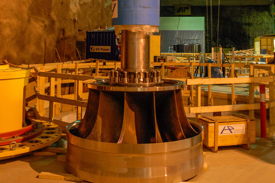 The shaft of the one Francis turbine towers inside the cavern